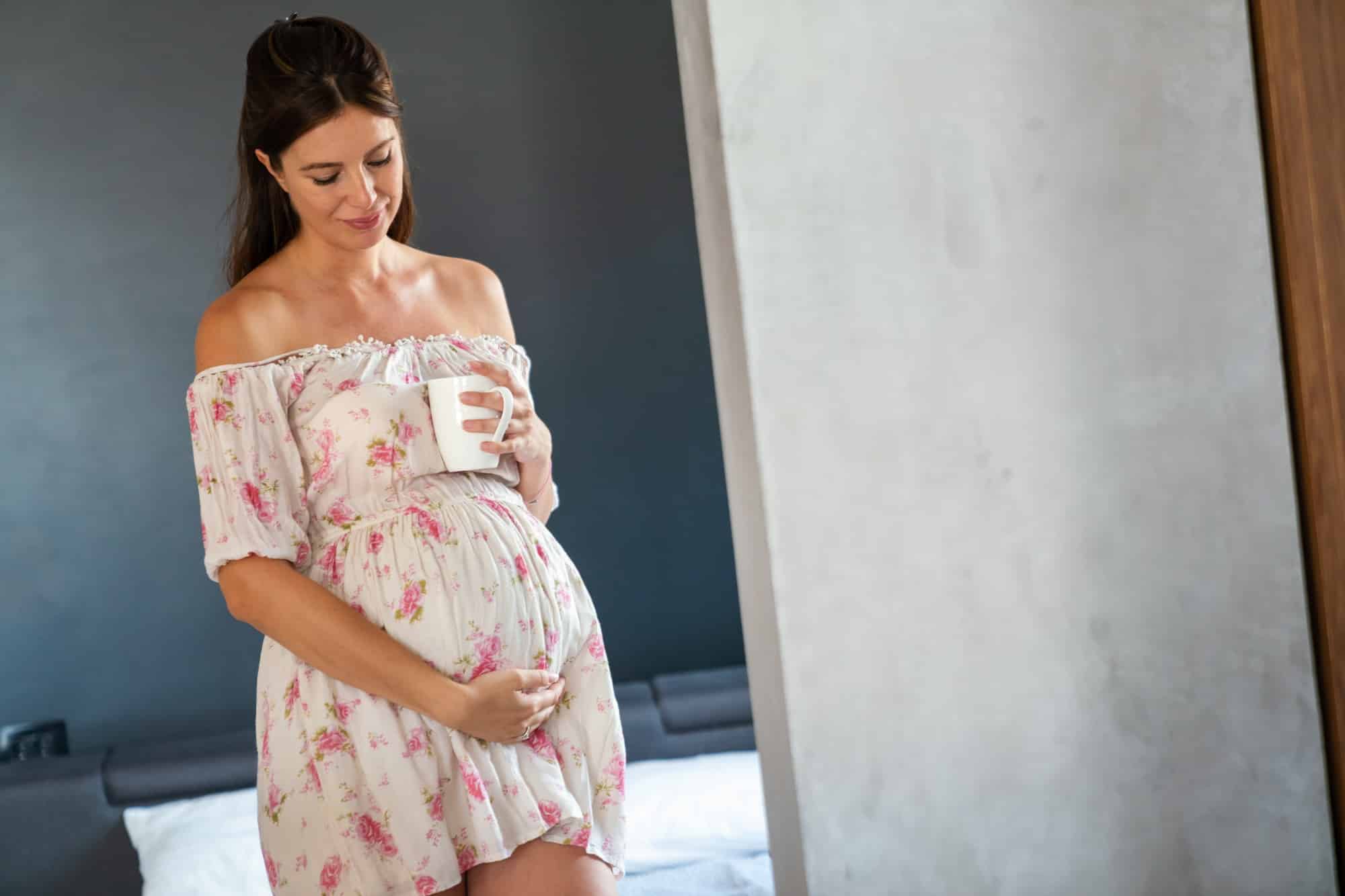 Care about perfect and smooth skin in pregnancy time. Pregnant woman using stretch mark cream